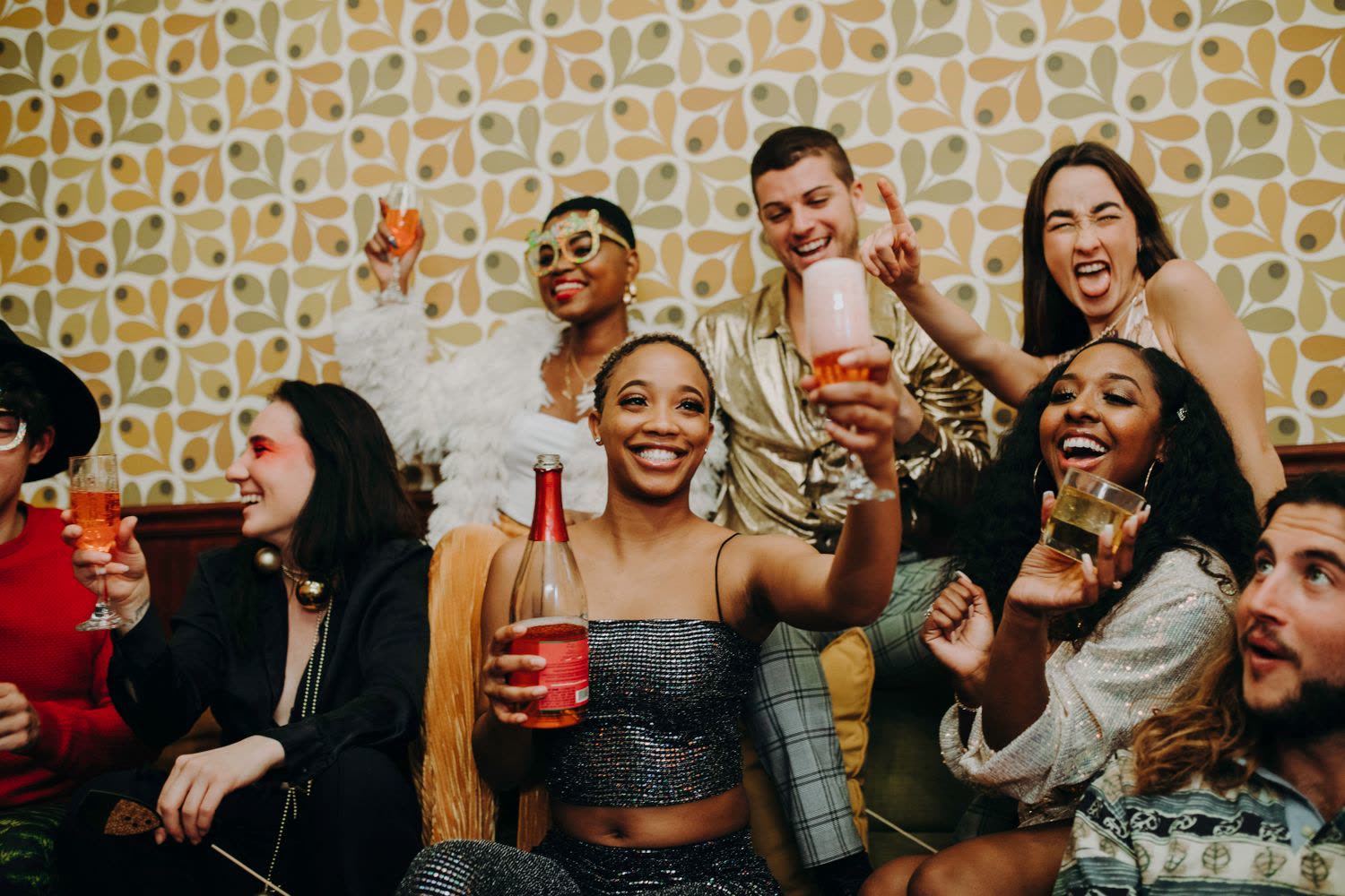 Guests cheering and raising glasses together at a birthday party